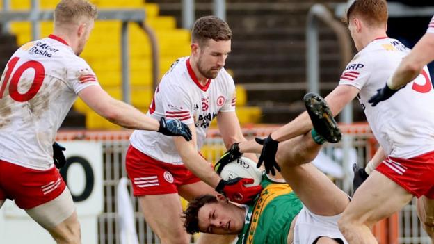 Tyrone players surround Kerry captain David Clifford