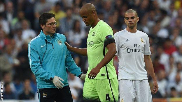 Vincent Kompany is helped off the pitch as Pepe looks on