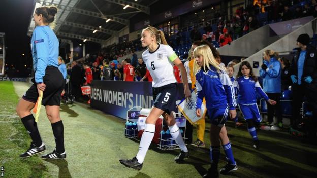 Leah Williamson leads out England team during the UEFA Womens U17 Championship Finals match between England and Austria at Chesterfield FC Stadium on November 29, 2013 in Chesterfield