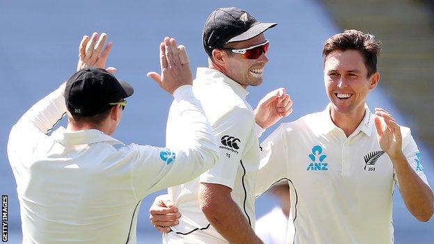 Trent Boult (right) and Tim Southee (centre) celebrate