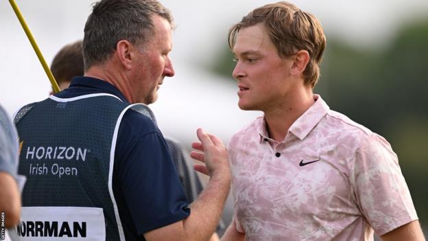 Vincent Norrman is congratulated by his caddie after his final round at the K Club