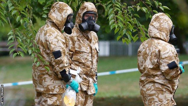 Masked officials investigate a nerve agent attack in Salisbury