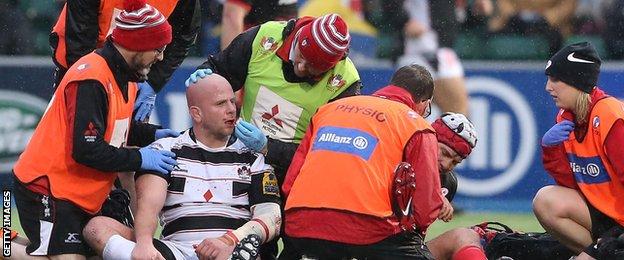 Gloucester's Nick Wood and Saracens' Schalk Brits receive treatment