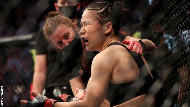 Zhang Weili looks stunned after being knocked out by Rose Namajunas