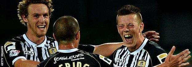 Callum McGregor celebrates with Notts County players