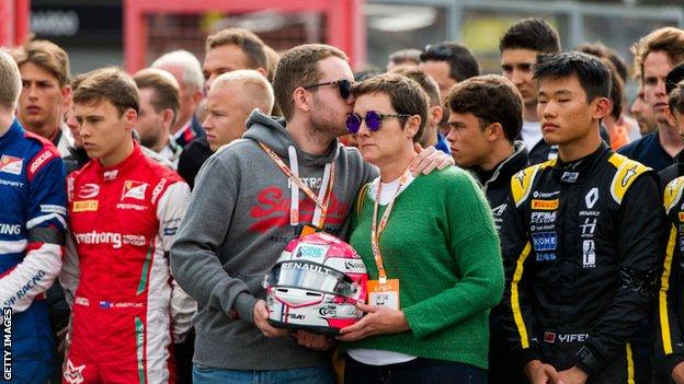 Anthione Hubert's family taking part in a minute's silence at the Spa-Francorchamps circuit in Belgium the day after his crash