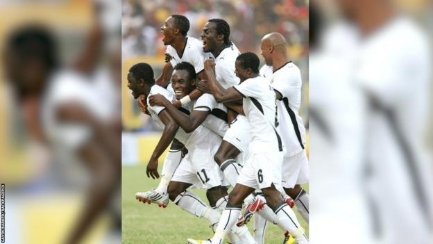 A beaming Michael Essien is pictured surrounded by five Ghanaian team-mates