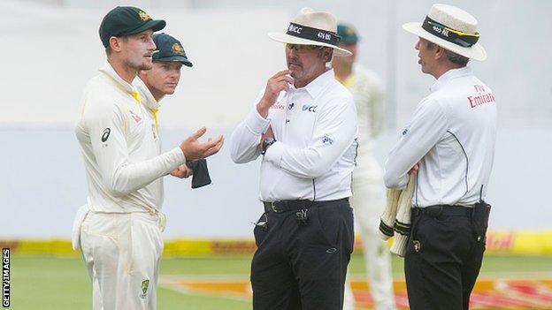 Australia's Cameron Bancroft speaks to umpires Nigel Llong and Richard Illingworth
