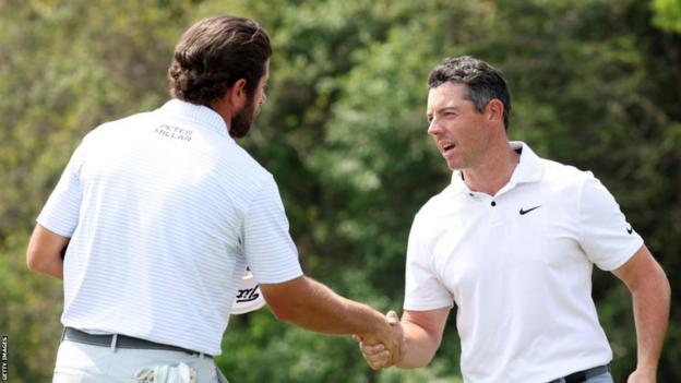 Rory McIlroy shakes hands with Cameron Young