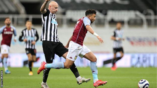 Newcastle's Jonjo Shelvey challenges Aston Villa's Trezeguet