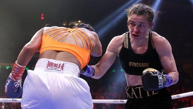 Katie Taylor lands a body shot in her victory over Amanda Serrano to retain her world lightweight title