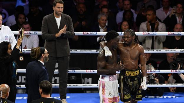 Josh Buatsi and Craig Richards following their fight, with Eddie Hearn in the background