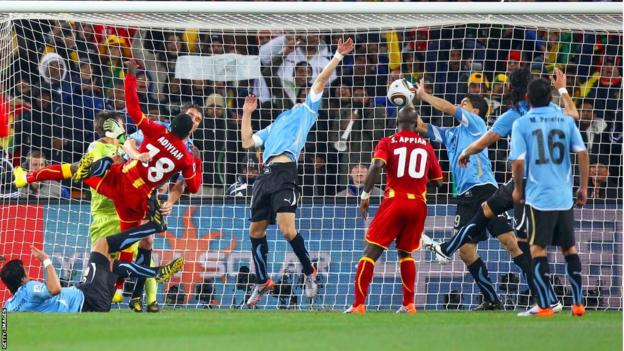 Luis Suarez handles the ball on the line against Ghana