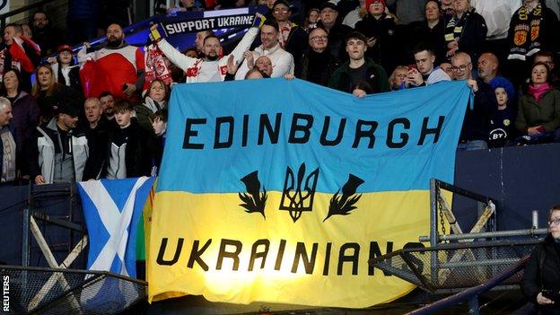 Fans display a banner in support of Ukraine amid Russian invasion