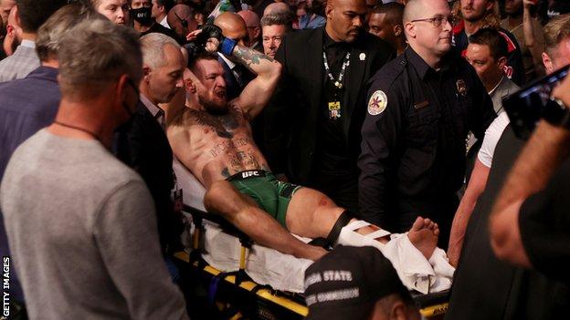 Conor McGregor is carried out of the octagon