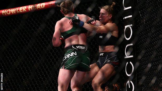 Molly McCann lands a spinning back elbow on her opponent