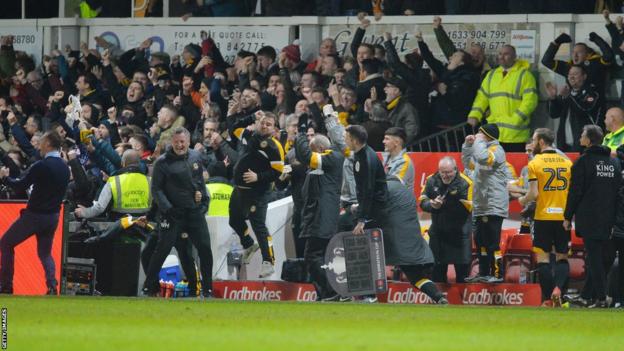 Newport's bench reacts to their winning goal v Leicester