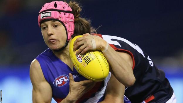 Heather Anderson is tackled playing Australian Rules