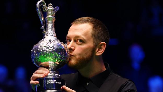 Mark Allen kisses the World Grand Prix trophy after winning the tournament.