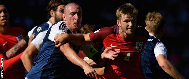 Scott Brown in action for Scotland against England's Eric Dier