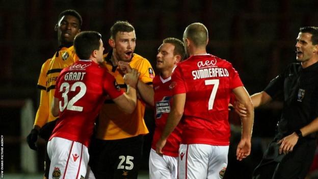 Mark O Brien of Newport County and Luke Summerfield of Wrexham clash during the clubs' last meeting, in 2018