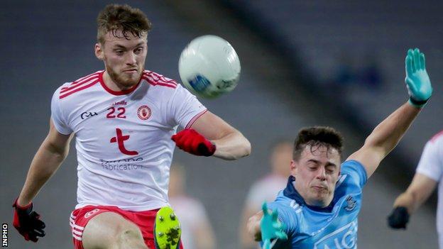 Tyrone's Brian Kennedy attempts a shot despite Brian Howard's effort to put in a block