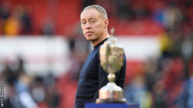 Nottingham Forest boss Steve Cooper looks at the Brian Clough trophy