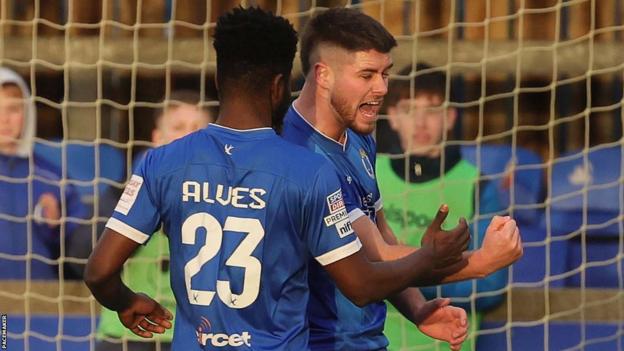 Ben Gallagher boosted Dungannon Swifts' survival hopes with a hat-trick against bottom side Newry City