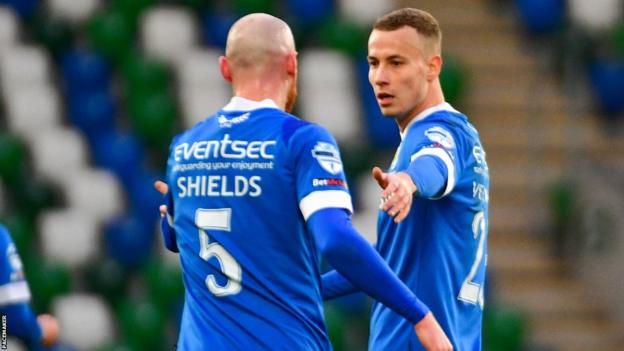 Chris Shields congratulates Linfield double goalscorer Eetu Vertainen