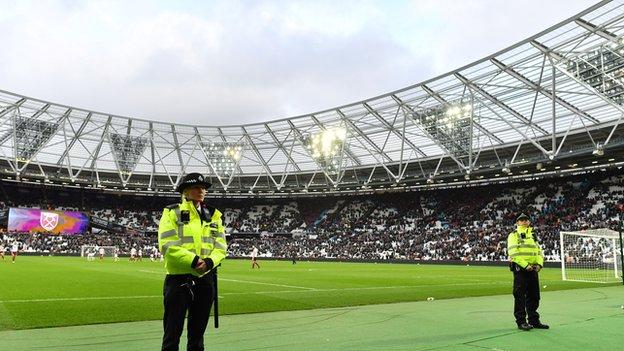 Police officers pitchside at The London Stadium