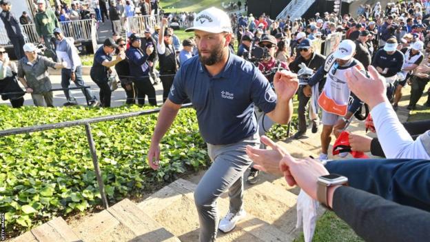 Jon Rahm salutes the crowd