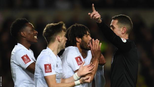 Arsenal players with referee David Coote during the FA Cup win against Oxford United