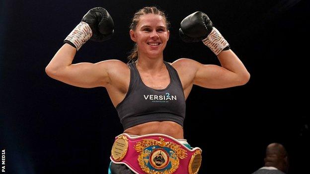 Savannah Marshall poses with her WBO belt after a win