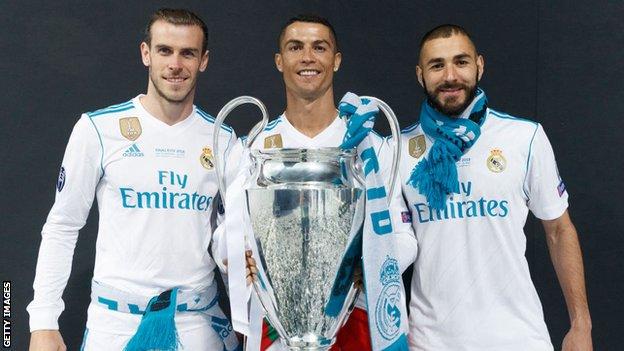 Gareth Bale, Cristiano Ronaldo and Karim Benzema pose with the 2018 Champions League trophy