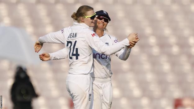 Charlie Dean and Danni Wyatt celebrate a wicket for England