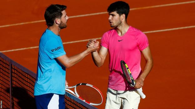 Spain's Carlos Alcaraz embraces Britain's Cameron Norrie