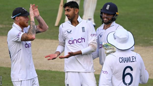 England's Shoaib Bashir celebrates the wicket of India's Axar Patel with Ben Stokes on day one of the second Test in Visakhapatnam