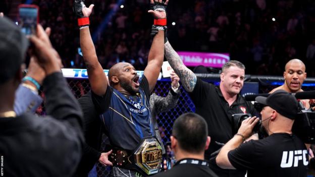 Jon Jones is elated while being presented with a UFC title