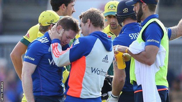 Eoin Morgan is checked over by the England physio