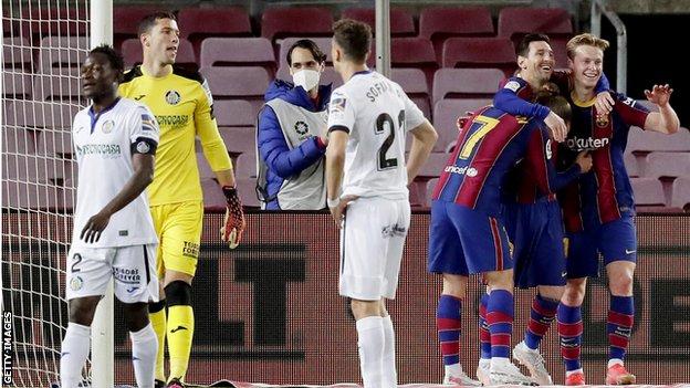 Barcelona's players celebrate scoring against Getafe
