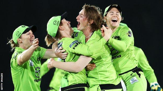 Sammy-Jo Johnson is mobbed after taking the wicket which sealed Sydney Thunder's place in the final