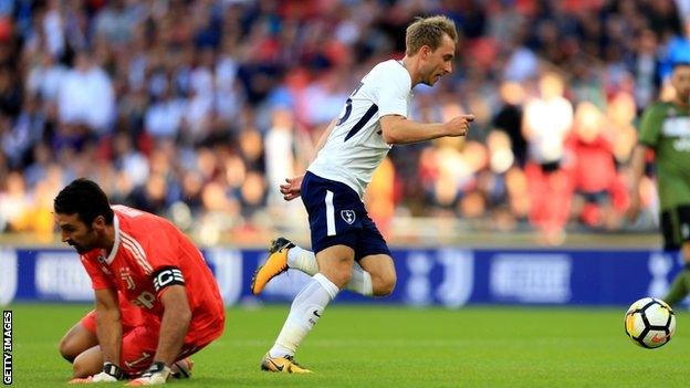 Christian Eriksen rounds Gianluigi Buffon to score