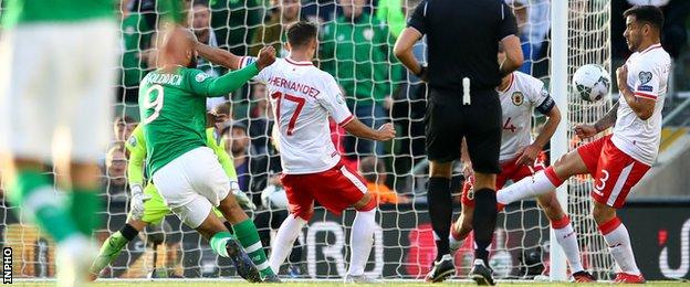 Ireland's David McGoldrick shoot deflects off Joseph Chipolina of Gibraltar to score his sides first goal