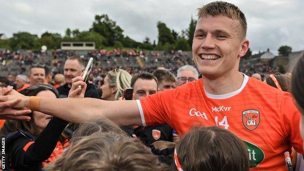 Rian O'Neill is congratulated by Armagh fans after his side's emphatic victory