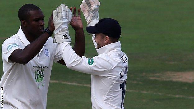 Keith Barker celebrates a wicket with his team-mates