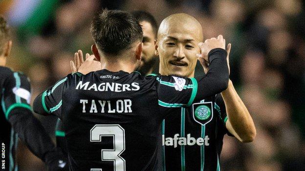 Celtic's Daizen Maeda and Greg Taylor celebrate as they make it 2-0 during a cinch Premiership match between Hibernian and Celtic at Easter Road