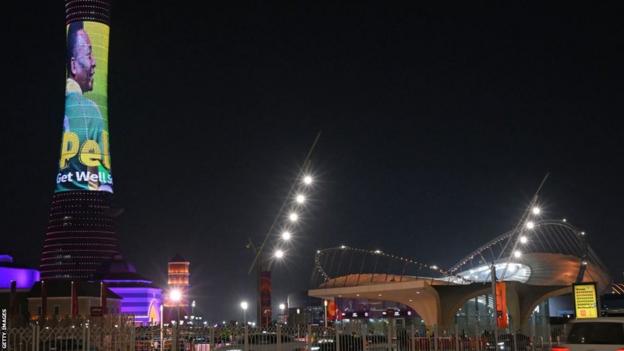 Doha's Torch Tower, aka Aspire Tower, is lit by a display depicting Pele reading a message in support of the former Brazilian player