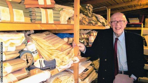 Charles Reep, pictured in his later years, pictured with many old notebooks of football match data stored in his garage