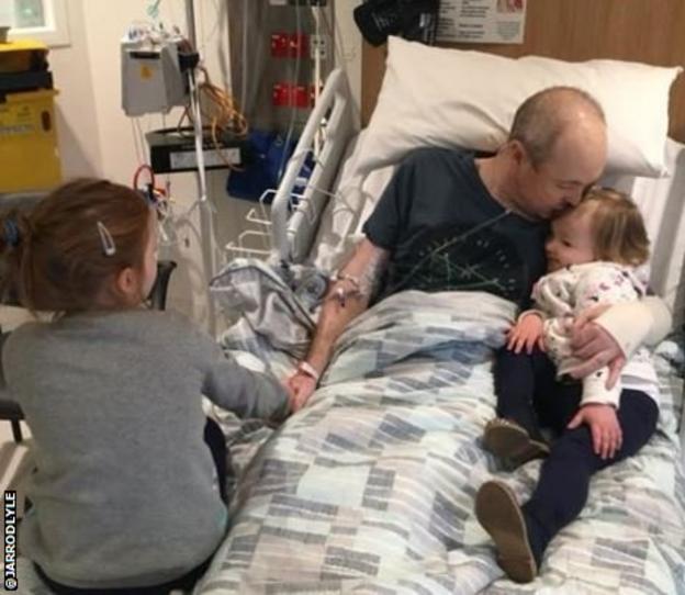Jarrod Lyle pictured in hospital with his two daughters