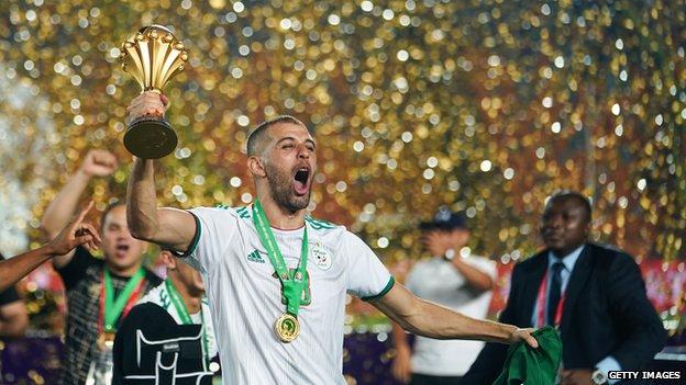 Islam Slimani holds aloft the Africa Cup of Nations trophy